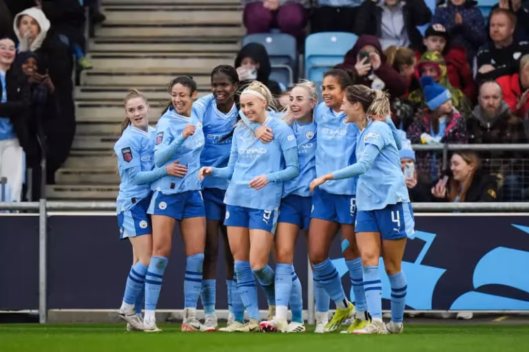 manchester women football team after a goal blue jersey
