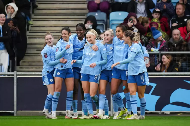 manchester women football team after a goal blue jersey